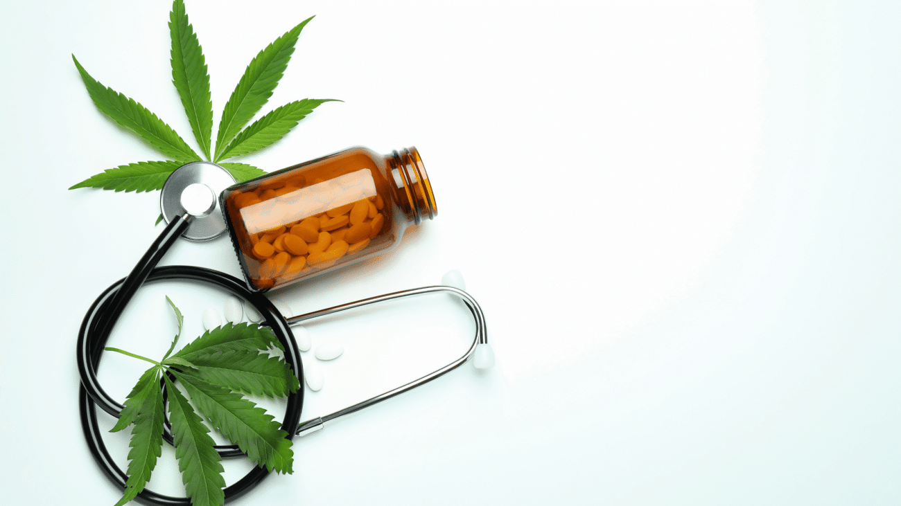 Medical cannabis concept with a stethoscope, cannabis leaves, and pill bottle representing cannabis for pain relief